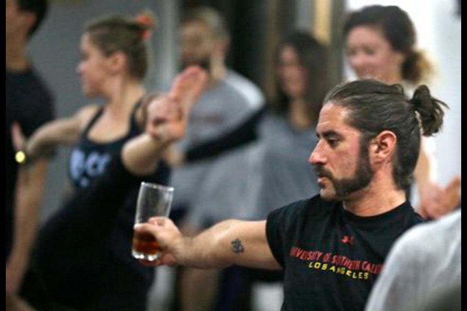Reed Patterson strikes a yoga pose with beer in hand at a class at the Platform Beer Co., in Cleveland, Ohio. The craft brewery has partnered with a local yoga studio to offer classes with a beer theme, primarily to get men in the door.