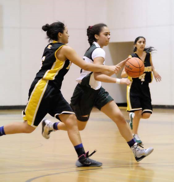 Running the floor, senior post Jacey Bailey, at right, enjoyed a monster tournament last week at Britannia. The Burnaby Mountain Lions player established five new tournament records, including scoring 12 treys in a game.