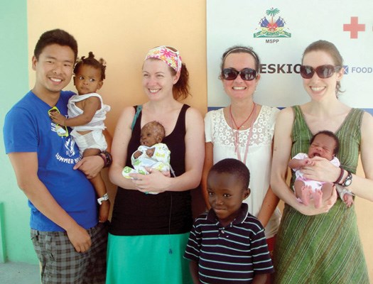 Lions Gate Hospital registered nurses Alfred Cheng, Megan Downey, Maria Pericak and Ashley Kirkwood team up for a photo with a few of the children they cared for, including Joseph and Sam, during a humanitarian trip to Haiti in May.