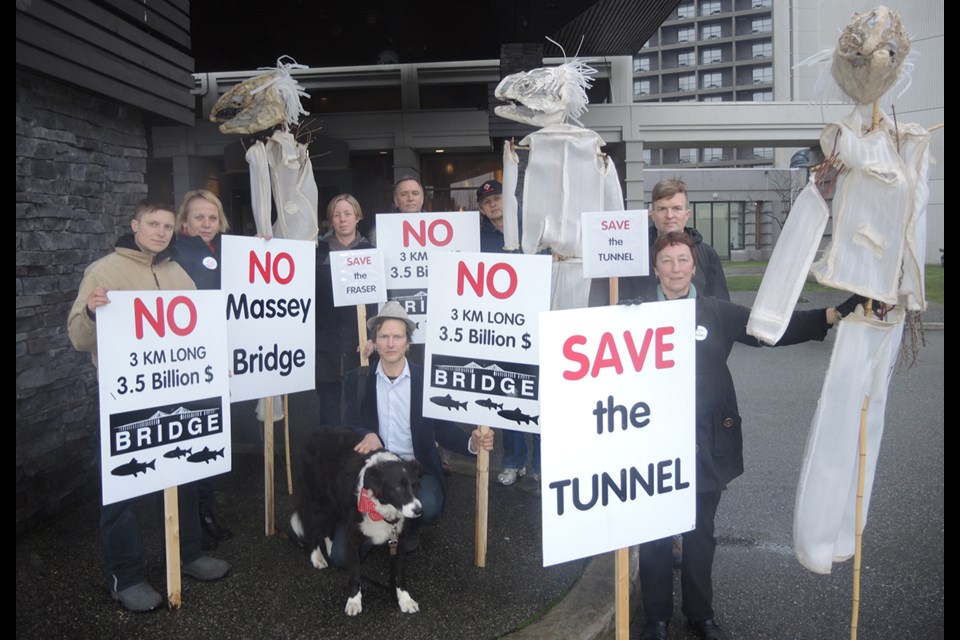 Farmwatch members, joined by Coun. Carol Day, second from left, protested the one open house for the George Massey Replacement Project (bridge) environmental assessment. Jan. 26, 2016.