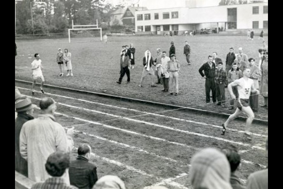 Victoria High School track athlete Don Burgess, right, setting a high-school record on the school&Iacute;s new track in 1951.