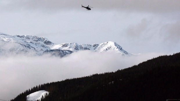 A search and rescue helicopter heads toward the area where a large avalanche struck near Revelstoke, B.C., in this Sunday, March 14, 2010 file photo. Five snowmobilers have died in a 'very large' avalanche near the Interior community of McBride, B.C., on Friday, prompting a rescue and recovery operation.