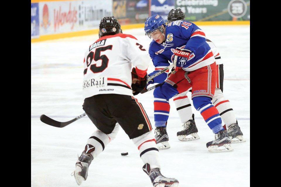 Prince George Spruce Kings Kyle Johnson gets checked from behind while trying get past Merritt Centennials Malik Kaila on Saturday at Rolling Mix Concrete Arena. The Centennials were in town to take on the Spruce Kings in regular season BCHL action. Citizen Photo by James Doyle January 30, 2016