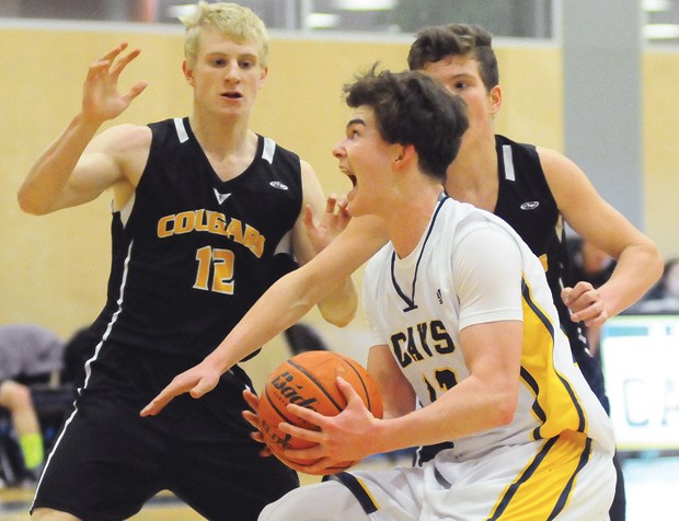 Collingwood’s Carter Armstrong muscles his way to the hoop during a North Shore senior boys league game against Elphinstone Jan. 19. Collingwood, a AA team, has staked its claim as the top squad on the North Shore with an undefeated record, including a win over AAAA West Vancouver. photos by Cindy Goodman