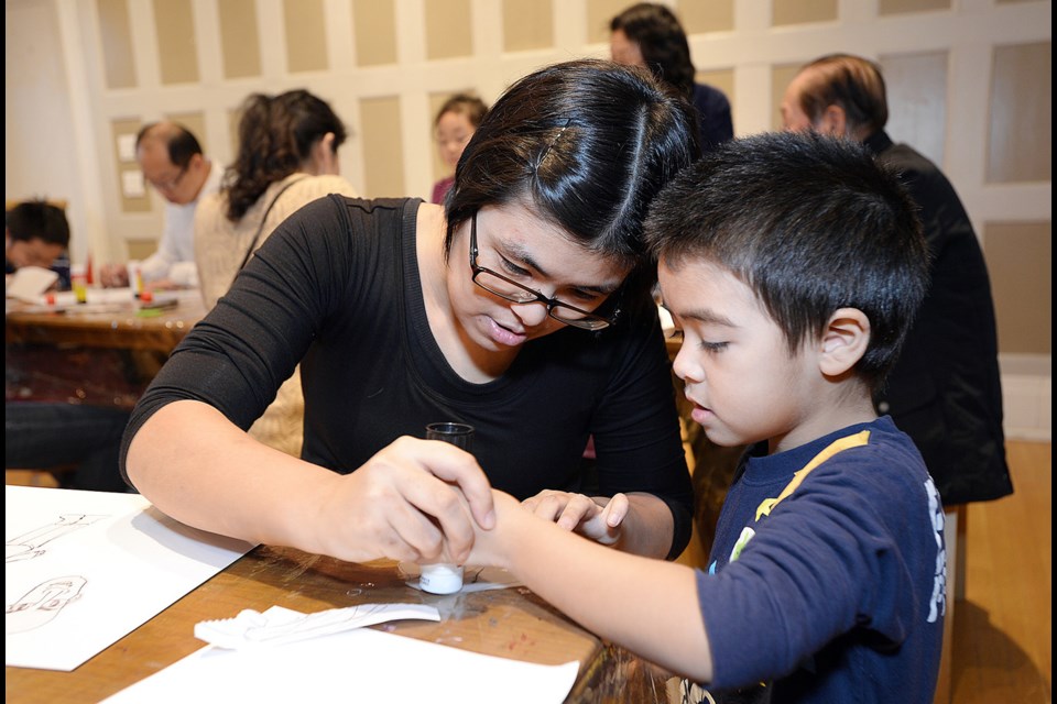 Nariko Nakamura and Kaede Boodagh take part in a Team Portrait session at Burnaby Art Gallery during last year’s Family Day event.