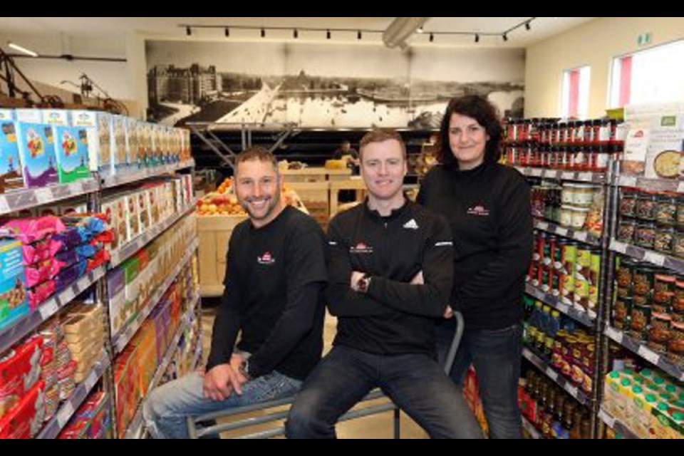 Russ Benwell, left, Scott Travers and Melissa Hazenboom at Red Barn Market's store on Oak Bay Avenue, which opens on Thursday.