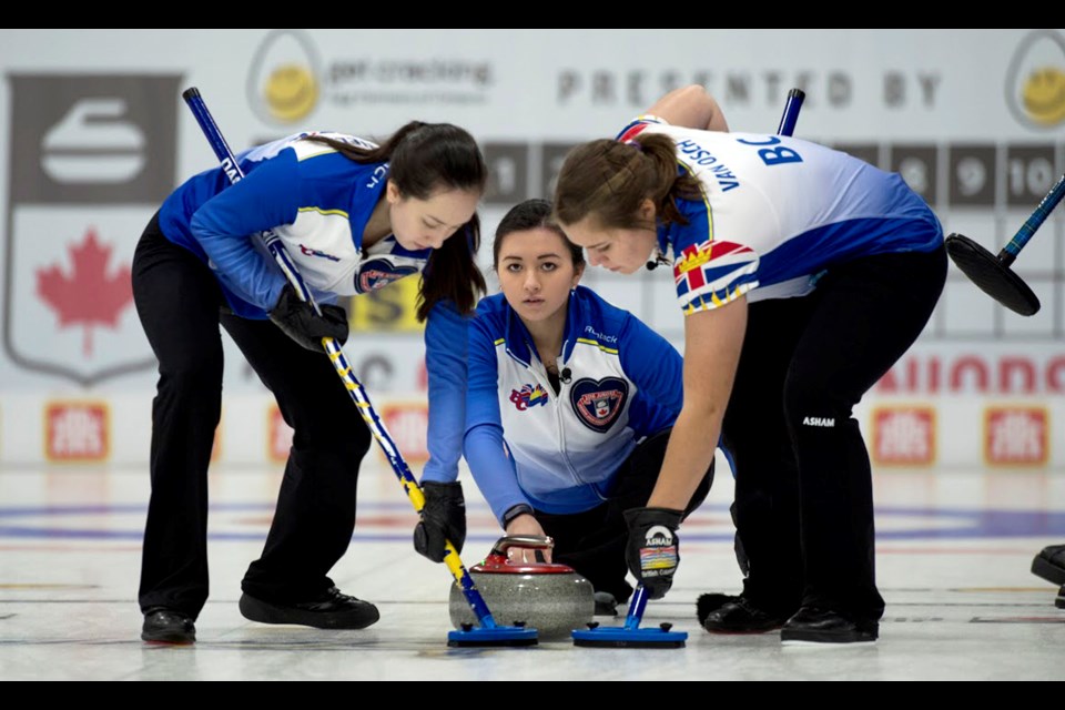 Team B.C.’s Megan Daniels, left, skip Sarah Daniels and Marika Van Osch, right, work another shot down to the house during Sunday’s Canadian Junior Women’s Curling championship final in Stratford, Ont.