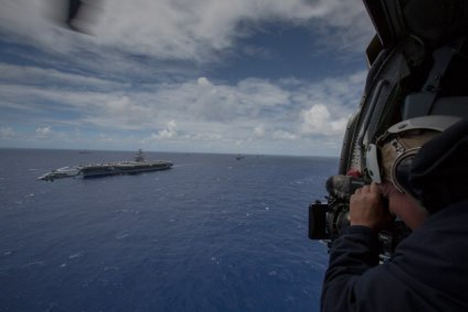 David Malysheff filming as ships and submarines participating in the Rim of the Pacific (RIMPAC) exercise in 2012 sail in formation in the waters around the Hawaiian islands.