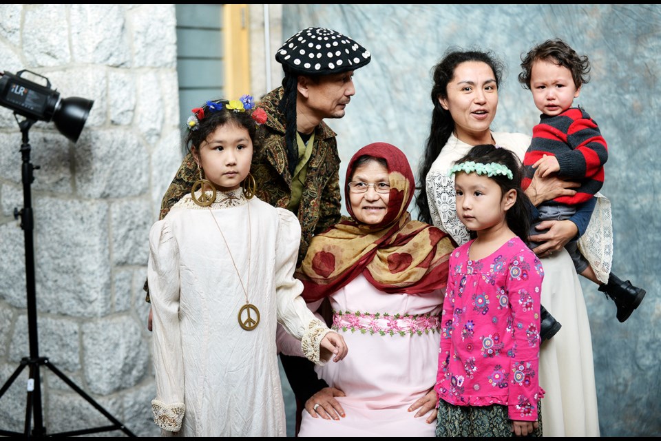 Arzu Imin, at right, and family get their portrait taken at Shadbolt Centre during an Art on the Spot Family Portraits event on Saturday, Feb. 6.