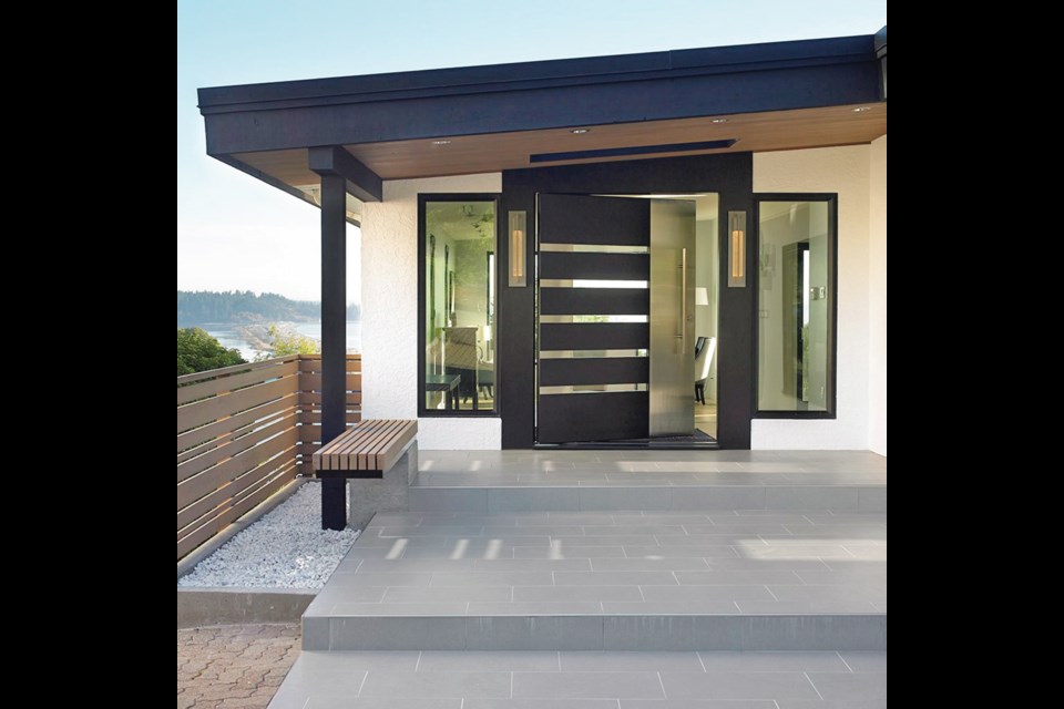 The custom-made front door is a unique feature, made by Aaron Stevenot at Karmanah Custom Joinery. It was technically difficult and tricky to construct because the owners wanted to be able to repair the glass if ever it were ever damaged. It was made so the stainless steel on the inside can pop off, and the strips of glass removed.