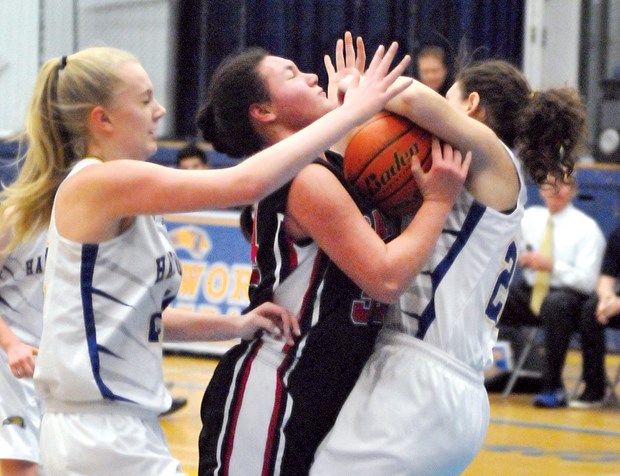 Handsworth’s Julia Strigl and Siobahn Parker put the squeeze on Carson Graham’s Georgia Nelson during a hard-fought North Shore AAA senior girls basketball final played Thursday at Handsworth. photo by Paul McGrath, North Shore News