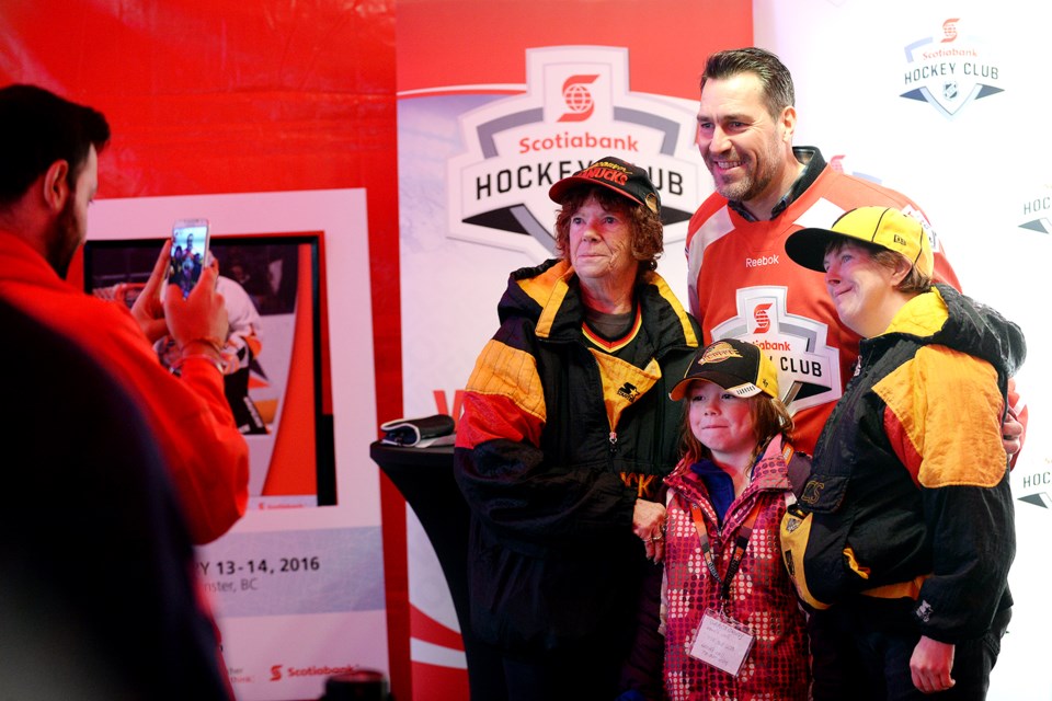 Former Vancouver Canucks goalie Kirk McLean poses with Kay Koroll, 6-year-old Grace Davey and Sharilyn Davey at the Rogers Hometown Hockey tour.