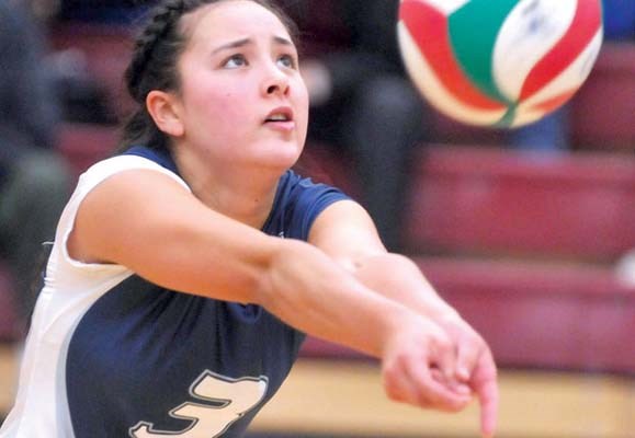 Capilano University Blues women volleyball action against Douglas College Royals. Capilano Blues #3 Jacqueline Caverly returns a serve.