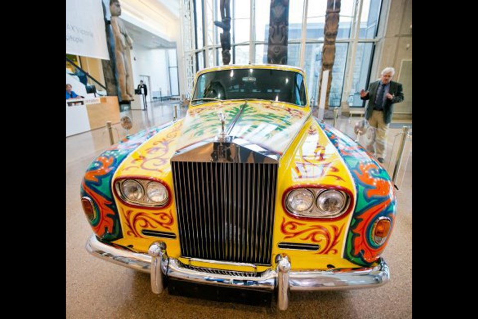 Royal B.C. Museum curator of history Lorne Hammond with John Lennon's Rolls-Royce in the museum's foyer.