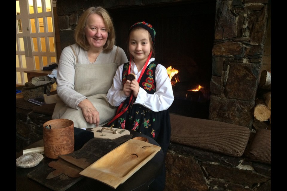 Carolyn Thauberger with her granddaughter Julianna, 8, both dressed in traditional Norwegian clothes. Thauberger is organizing the Nordic Design 2016 show this coming weekend.