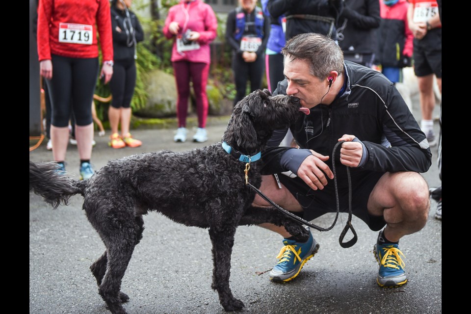 A man and his dog share a pre-run kiss during Saturday’s Dash for Dogs at Stanley Park. The second annual fundraiser for the BC & Alberta Guide Dogs charity, was hosted by RunGo which is an app created by Craig Slagel who adopted a retired guide dog. Photograph by: Rebecca Blissett