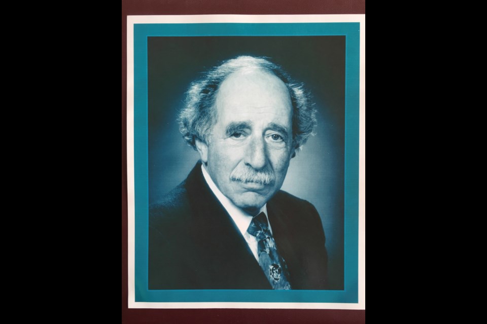 This photo Harry Rankin at age 60 sits on Tim Louis’ credenza at work.