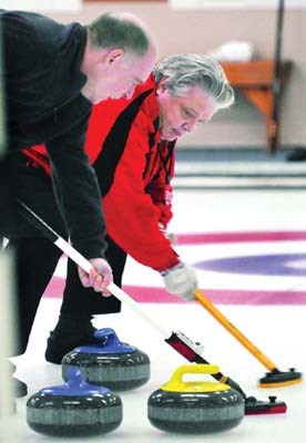 North Shore Winter Club curler Ken Nowell (left) and John Ribalkin compete in the kickoff to the 100 year old Strathcona Cup curling tour. Visiting Scottish curlers will compete against rinks across Canada for the next month.