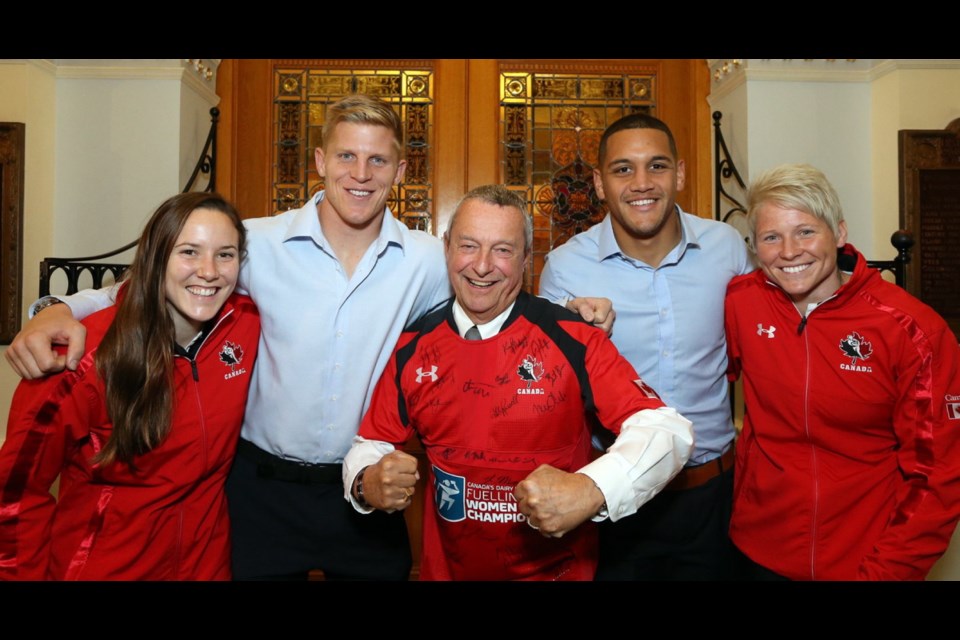 Peter Fassbender, minister of Community, Sport and Cultural Development, middle, was presented with an autographed national rugby team jersey on Monday at the legislature as Rugby Canada&Otilde;s recent successes were acknowledged during a ceremony at the B.C. legislature. On hand for Rugby Canada were, from left, Natasha Watcham-Roy, John Moonlight, Michael Fuailefau and Jenn Kish.