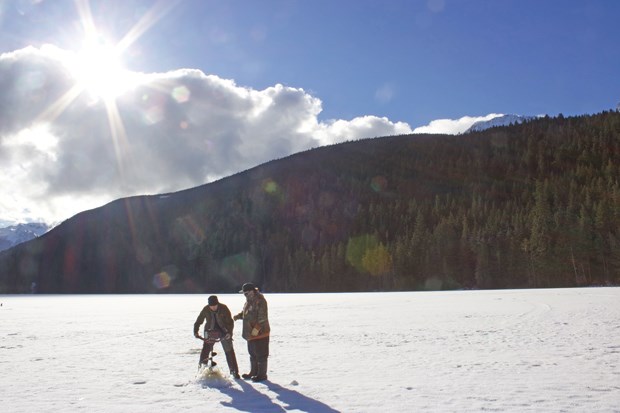 Brad Knowles’ Pemberton Fish Finders drill a hole through the ice at Blackwater Lake.