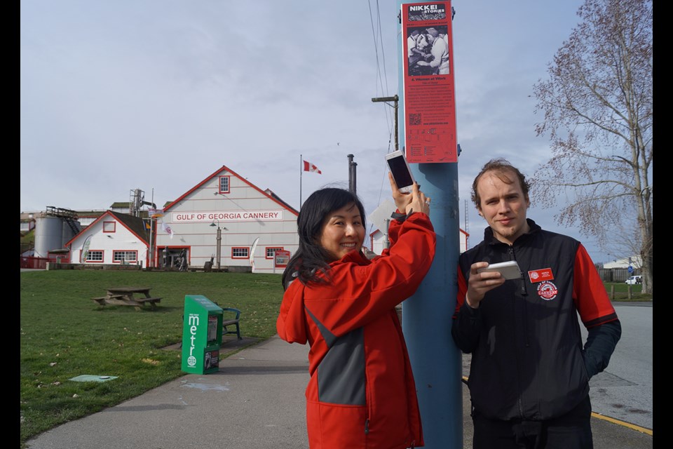Mimi Horita and Andrew Wade, employees at the Gulf of Georgia Cannery, try out the new Nikkei Stories walking tour. Ten signs have been posted throughout Steveston village, with each prompting mobile device users to watch a three-minute video on local Japanese-Canadian history.