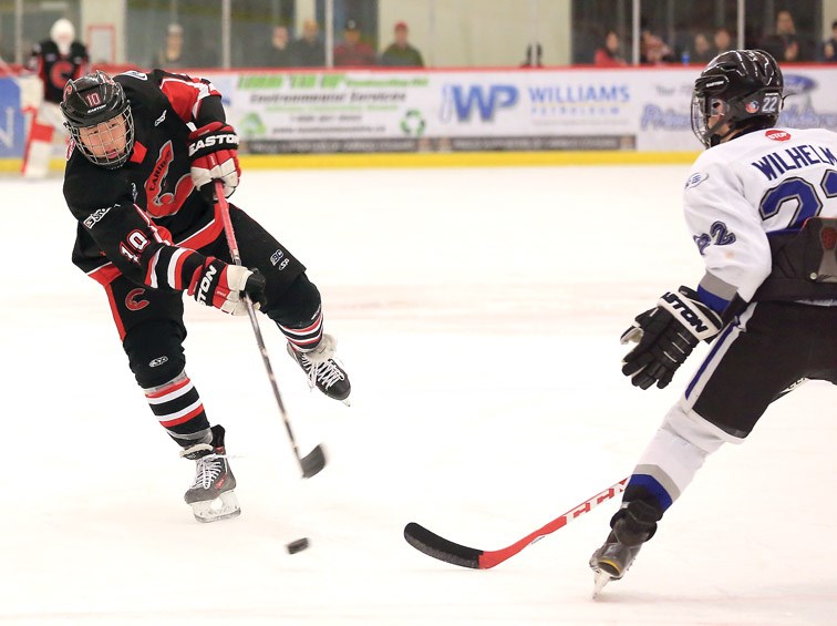 Cariboo Cougars Tyler Ho tries to shoot the puck past South Island Royals Jake Wilhelm on Saturday at Kin 1. The Royals were in town to take on the Cougars in the second game of the best of three series between the two teams. The Cougars lead the series 1-0 with a 6-0 win on Friday. Citizen Photo by James Doyle March 5, 2016