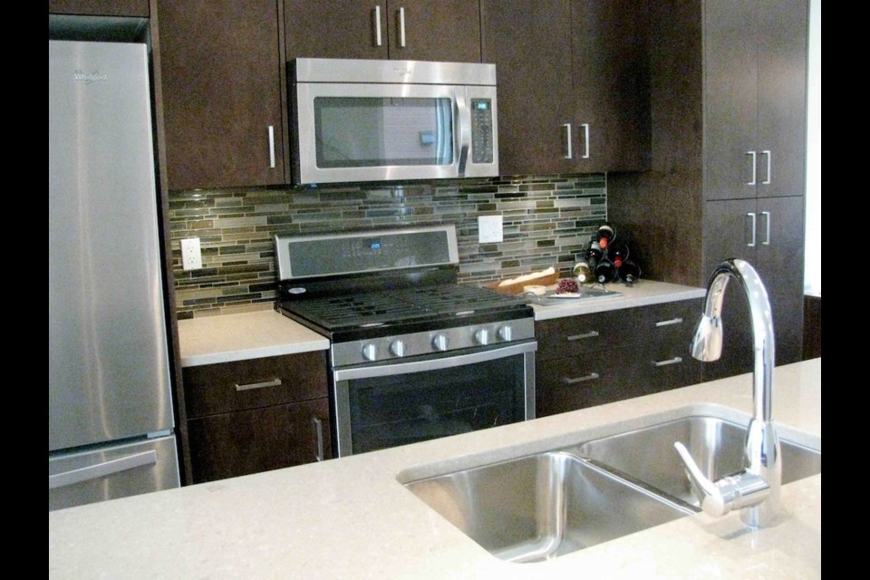 The kitchen in this Esquimalt townhouse has a large island and a gas-powered stove. If, however, you don't care for cooking with gas, don't worry -- the wiring is laid on for an electric stove.