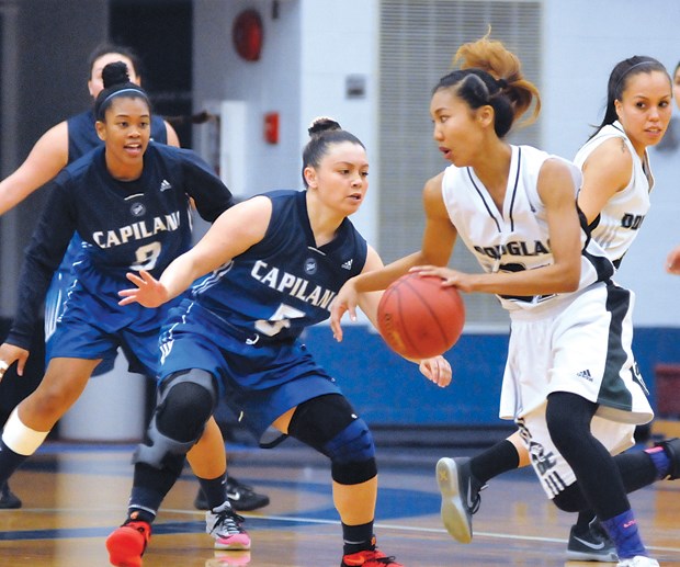 Capilano University’s Francis Penafiel and Jennafer Palma track a Douglas College dribbler during the semifinals of the PacWest basketball championships held last week at Capilano Sportsplex. The Blues went on to win silver. photo by Paul McGrath, North Shore News