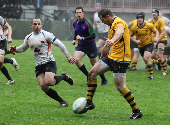 Cap player kicks the ball.