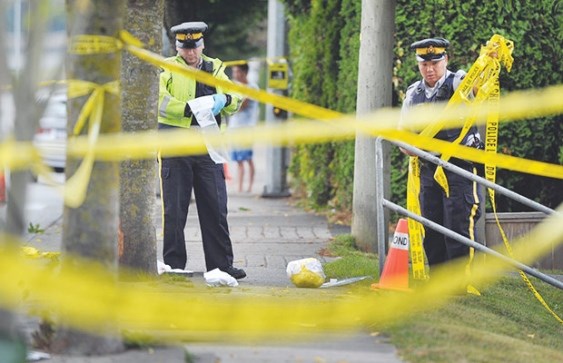 Police survey the scene on No. 5 Road near Highway 91, where a 64-year-old cyclist was killed in September 2013