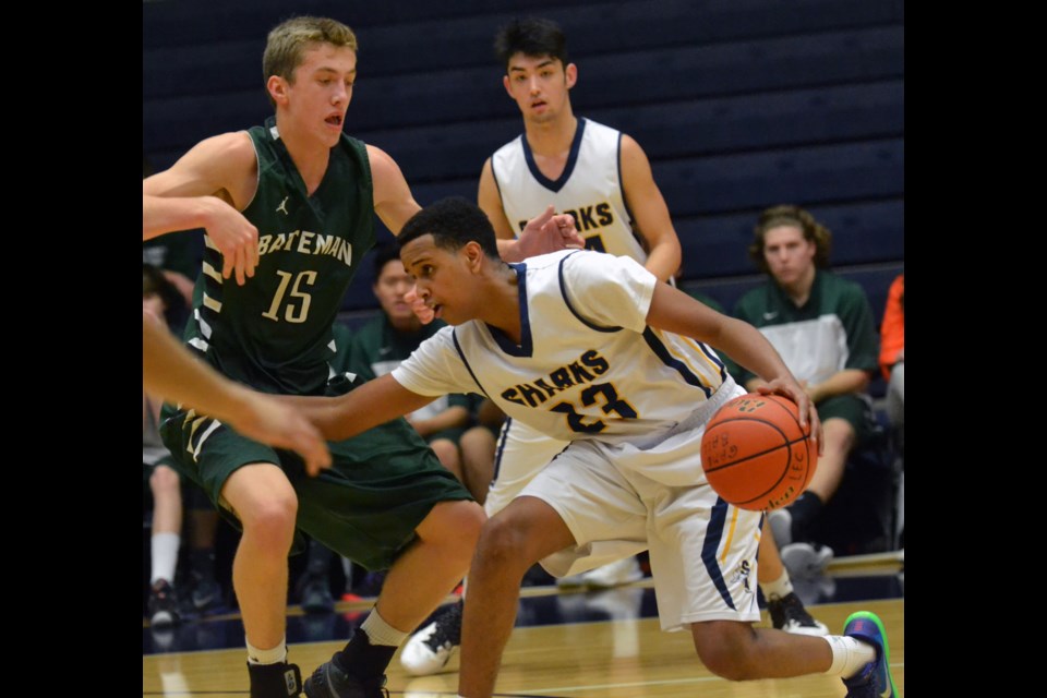 Steveston-London's Ahmed Mohamud works his way through traffic during his team's quarter-final win over Bateman Thursday at the BC AAA Boys Basketball Championships.