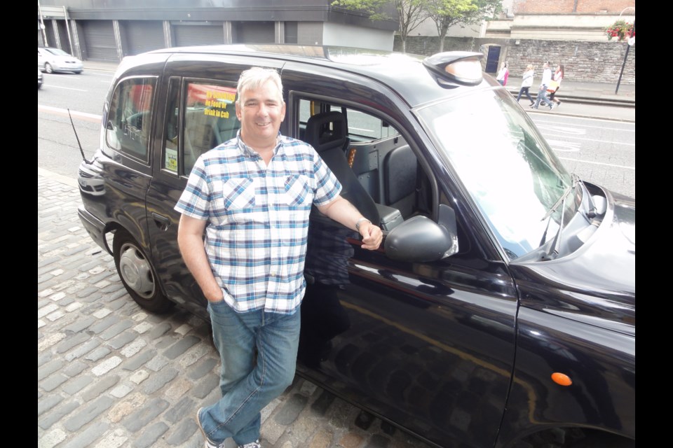 Billy Scott and his black cab in which he shows the sights and tells the stories of Belfast.