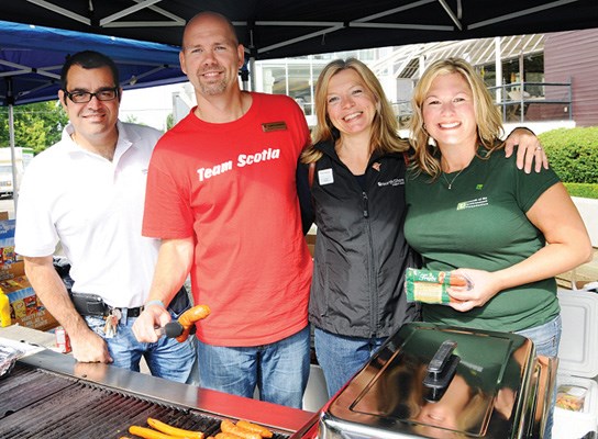 HSBC's Biagio Marra, Scotiabank's Larry Clements, North Shore Credit Union's Linda Reddin and TD's Lisa Richardson man the grill.