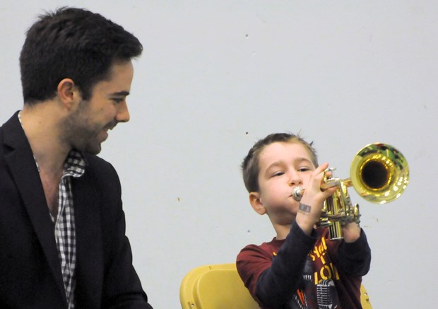 Dylan Ritchie blows his horn as trumpeter Andrew Lennox watches.