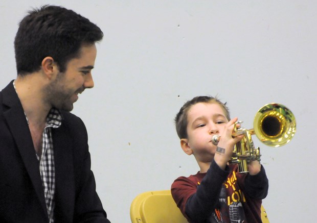 Dylan Ritchie blows his horn as trumpeter Andrew Lennox watches.
