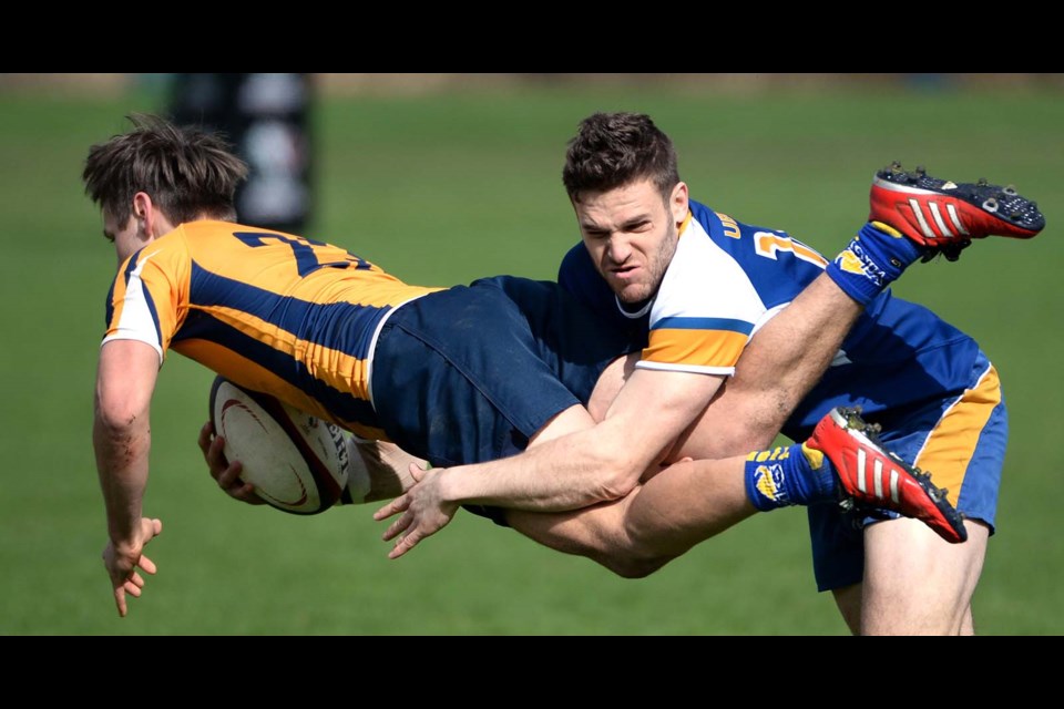 Matt Anderson can't avoid UBC's Sean Hickson's tackle during final day action at the Canadian University 7s rugby tournament at Burnaby Lakes.