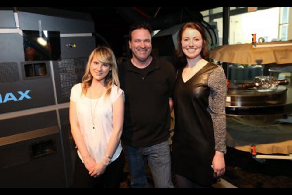 Imax Victoria projectionist Jason St. Louis takes a break in theatre's revamped projection booth with superfans Maria Carere, left, and Elizabeth Mifsud-Sweeney.