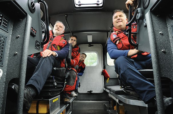 Dugal Purdie, Dan Sampson, Peter Matthews and Ian Grantham sit in comfort aboard the new vessel. In the old boats, which were only partially enclosed, two crew members had to ride standing up at the back of the vessel in the open.