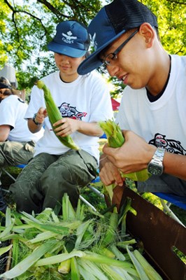West Vancouver 525 Pathfinders Squadron Cadets Lucy Fang and Eric Wei shuck cobs of corn for the Coho Festivals famous salmon barbecue.