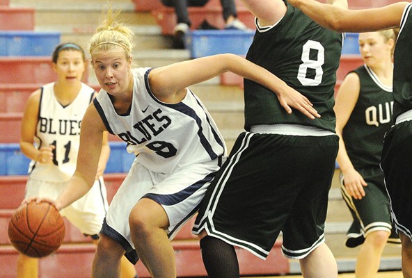 Capilano University women's Blues basketball (white) in action against Quest University.