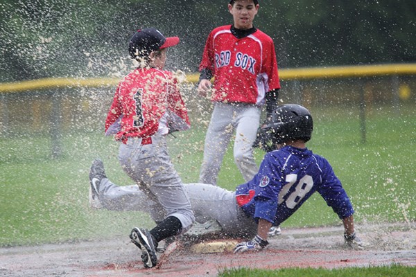 Mt. Seymour player Carter Burt Lake catches water as he tries to tag out
Cole Dalla-Zanna in the final game of the Majors Baseball Tournament May 21.