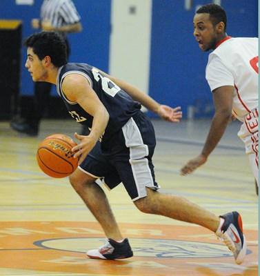 Sentinel's Oscar Oritz moves the ball down the court.