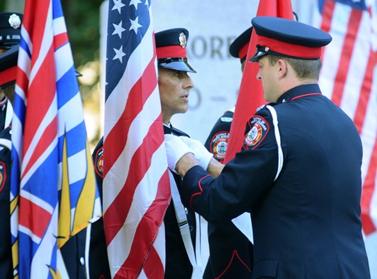 Firefighters in the Colour Party make the finishing touches before marching during the September 11th memorial ceremony.