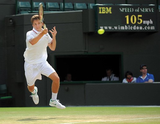 Filip Peliwo blasts a return in the Wimbledon junior boys championship match. The 18-year-old won the final 7-5, 6-4.