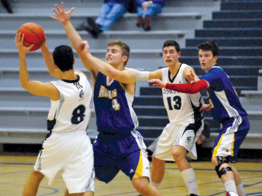 Sentinel's #8 Sam Lofti (white) tries to get past Handsworth's #4 Luka Petkovic as Sentinel's #13 Charlie Morrison and Handsworth's #9 Charlie Horn look on during the Howe Sound AAA Boys Basketball championship final at Sentinel Secondary.