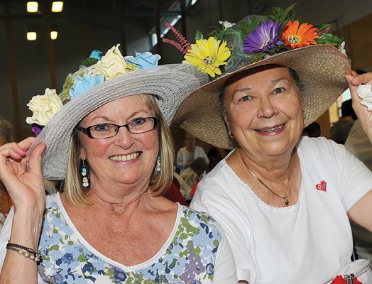 Marilyn Kinnee and Audrey McNeal show off their flower hats.