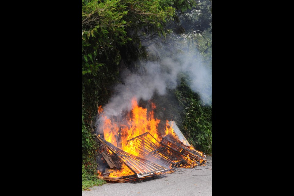 A fire spread quickly from some discarded mattresses into nearby trees in the alley behind a Chevron Station at 23rd Street and Lonsdale Avenue in North Vancouver Tuesday. Firefighters were on scene within minutes.