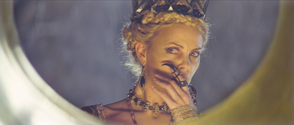 Charlize Theron, as the evil Queen Ravenna, has the juiciest role and the best wardrobe in Snow White and the Huntsman.