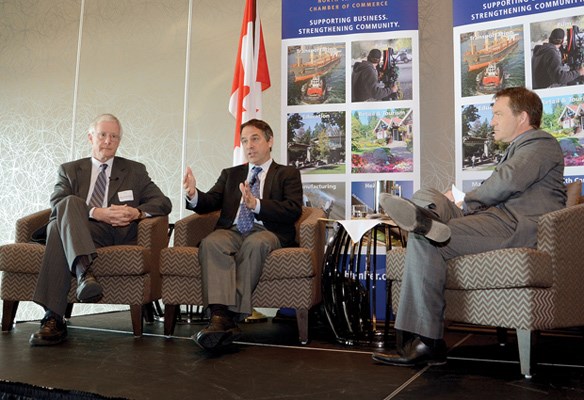 Mayors Richard Walton and Darrell Mussatto with moderator Mike Watson on the stage.