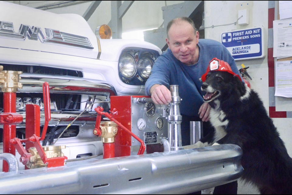Brian Borsoff and his pup Remley pose for a photo next to a 1959 GMC Delta fire truck. Borsoff, who owns Burnaby Auto Body on Douglas Road, and his team have spent the better part of a year restoring the fire truck for the Delta Fire Department.